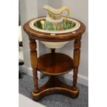 A Late Victorian Walnut and Parcel Gilt Circular Washstand, with turned and fluted supports raised