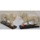 A Pair of Painted Cast Stone Figures of Lions, each standing, a forepaw on a ball, on rectangular