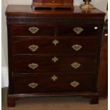 A George III Mahogany Five Drawer Straight Front Chest, with blind fret carved frieze above two