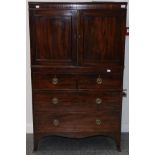 A George III Mahogany Dwarf Linen Press, early 19th century, with two cupboard doors enclosing an