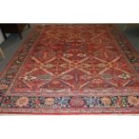 Sultanabad Carpet West Iran, circa 1920 The tomato red field of diamond lattice design containing