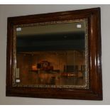 An 18th Century Walnut and Parcel Wall Mirror, the rectangular mercury mirror plate within a gilt