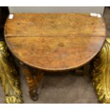 A Drop Leaf Coffee Table, in 17th century style, with two rounded leaves to form an oval, raised