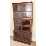 A Mahogany and Satinwood Banded Six Piece Sectional Bookcase, circa 1900, with eight glazed doors