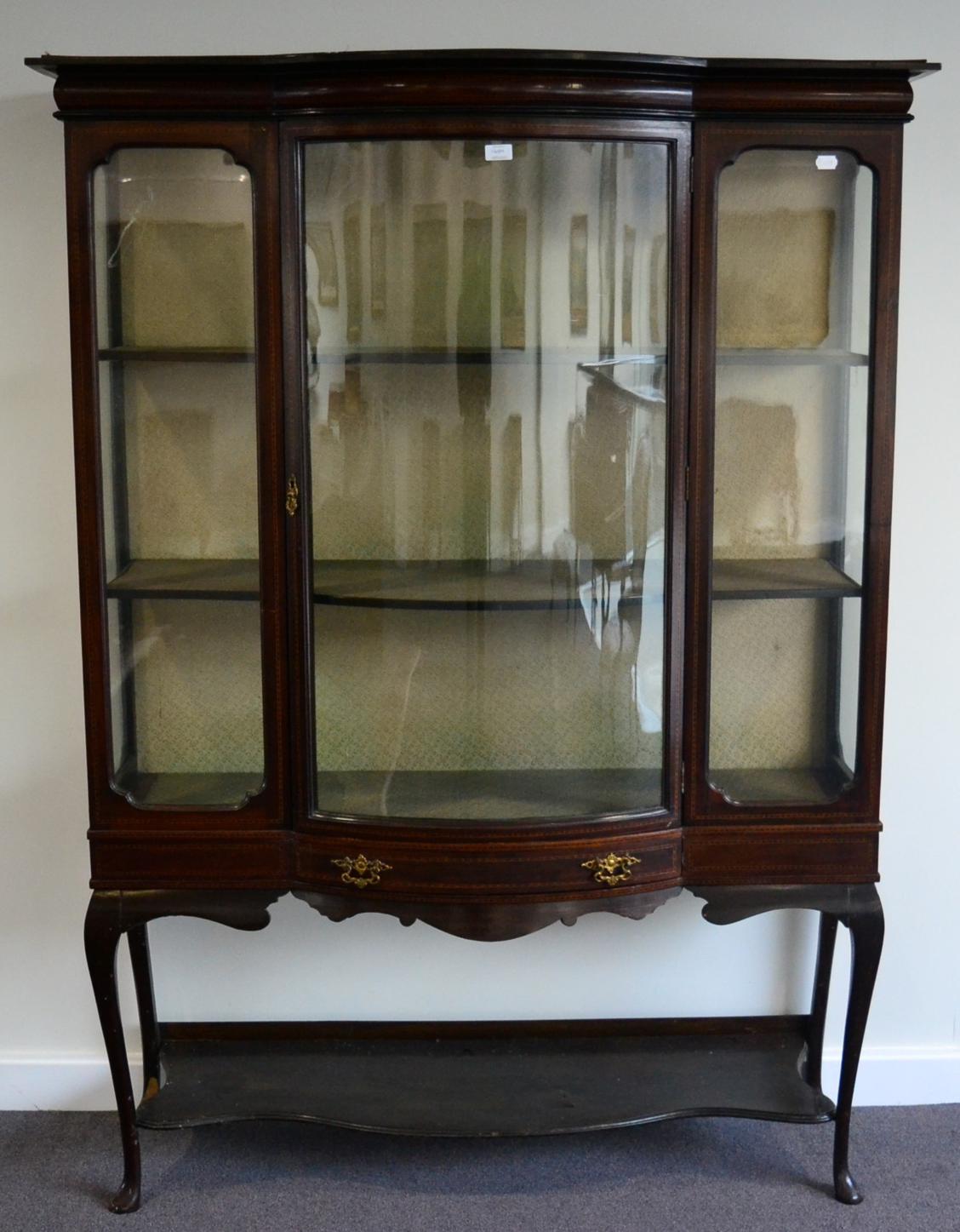 An Edwardian Mahogany and Barber's Pole Strung Display Cabinet, with central glazed door enclosing a