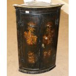 A George III Japanned Bowfront Hanging Corner Cupboard, 3rd quarter 18th century, with two