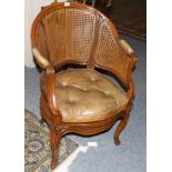 A Late 19th/Early 20th Century Walnut Framed Bergère, with caned back support and seat,