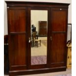 An Early 20th Century Mahogany and Ebony Strung Triple Door Wardrobe, with central mirror door