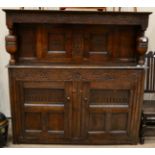 A Joined Oak Press Cupboard, late 17th/early 18th century, with carved frieze above two cupboard