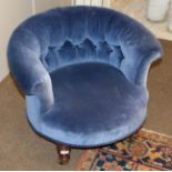 A Victorian Tub Framed Armchair, circa 1870, recovered in buttoned blue velvet with rounded back