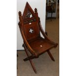A Victorian Gothic Revival Cross Frame Chair, late 19th century, with a fret carved architectural