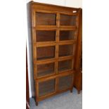 An Early 20th Century Oak Bookcase, in five section with eight conforming glazed doors, with two