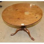 A George III Mahogany Circular Tripod Table, late 18th century, the flip top raised on a baluster