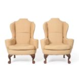 A Pair of Victorian Wing Back Chairs, late 19th century, in George II style, recovered in cream