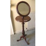 A Victorian Pine Valet Stand, late 19th century, with a circular mirror mounted on an adjustable