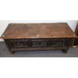 A 17th Century Italian Carved Walnut Cassone, with hinged lid above a foliate carved front panel,