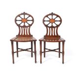 A Pair of George III Mahogany Hall Chairs, late 18th century, with oval backs centred by satinwood