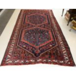 Bakhtiari Rug West Iran, circa 1930 The chestnut field with two stepped indigo lozenges of