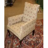 A Victorian Armchair, upholstered in beige and pink floral fabric with rounded arms and