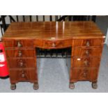 A Late Regency Mahogany Bowfront Desk, early 19th century, with a bowfront drawer flanked by eight