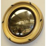 A Regency Gilt and Gesso Circular Convex Mirror, early 19th century, with a reeded mahogany slip