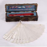 A 19th Century Chinese Mother of Pearl Brisé Fan, with 19 sticks and two guards carved with scenes