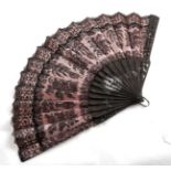 Circa 1880-1900 Black Chantilly Lace Fan, backed with pale pink silk, mounted on carved black wooden