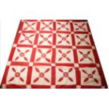 19th Century Red and White Patchwork Cover, appliqued with tulips within red squares and red trim,