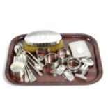 A quantity of silver including a cigarette case; napkin rings; spirit labels; teaspoons; silver