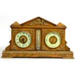 An Edwardian gilt metal mounted oak cased combination clock, barometer and thermometer; the