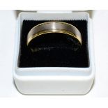 An 18 carat two colour gold band ring, finger size T8.8g