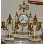 A portico striking mantel clock with garniture
