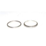 Two band rings, one with chased decoration, finger size O and M, each stamped 'PLATINUM' (2)Gross