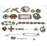Nine various Scottish hardstone and paste brooches; a silver plaid brooch; a silver buckle (a.f.);