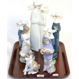 Six Lladro figures comprising; four nuns, a young girl holding a cat basket, a dog, and a Nao figure