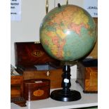 A 12 inch Terrestrial globe by W & A.K. Johnston Edinburgh, on ebonised stand together with a 19th