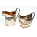 A George III silver helmet form cream jug with Victorian decoration, together with another silver