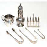 A group of silver comprising, an octagonal baluster caster, a four division toast rack, cream jug