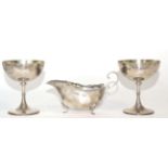 A pair of silver wine cups with gilt interiors, marked for London together with a silver sauce