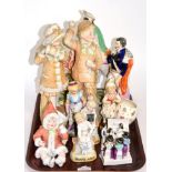 A collection of figures, including a Staffordshire Prince Albert and a Scotsman on a horse; four