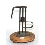 An early adjustable birdcage candlestick, on a split turned wood base
