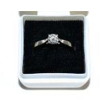 A platinum solitaire diamond ring, a round brilliant cut diamond in a claw setting, to knife edge