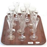 A set of eleven champagne flutes with bell knop stems