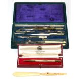 An Asprey 9 carat gold engine engraved propelling pencil, cased; a Stanhope viewer and a set of