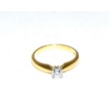 An 18 carat gold solitaire diamond ring, a round brilliant cut diamond in a claw setting, to knife