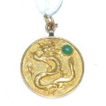 A Chinese 'Good Fortune' pendant, circular with the motif of a dragon chasing a jade cabochon and '