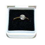 An 18 carat gold solitaire diamond ring, a round brilliant cut diamond in a broad rubbed over