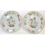A pair of 18th century Chinese export plates, painted with flowers and precious objects