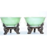 A pair of Chinese celadon dishes, with wooden stands (2)