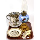 A Victorian oil lamp with painted glass reservoir, a silver lustre twin handled trophy cup